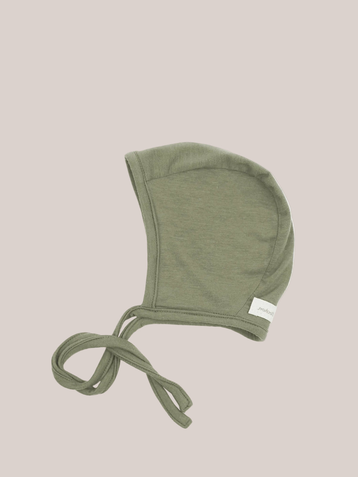 Cashmere-blend baby bonnet – pistachio, a soft olive-green knitted bonnet with long ties made from stretchy micromodal-cashmere fabric, providing warmth and protection for delicate baby heads.