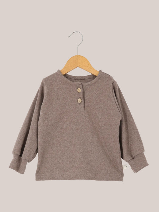 Hemdchen Feinstrick - Praline: Ein einfaches, langärmeliges Henley-Shirt mit Rundhalsausschnitt und Zweiknopfleiste, gefertigt aus feinem Strickstoff. Ideal für den Alltag, bequem und anschmiegsam.