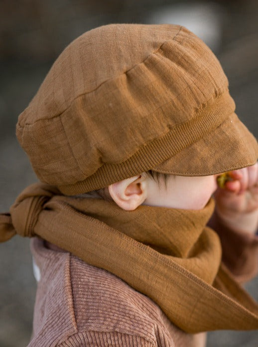 Child with sailor cap, muslin fabric, and Sahara muslin cloth